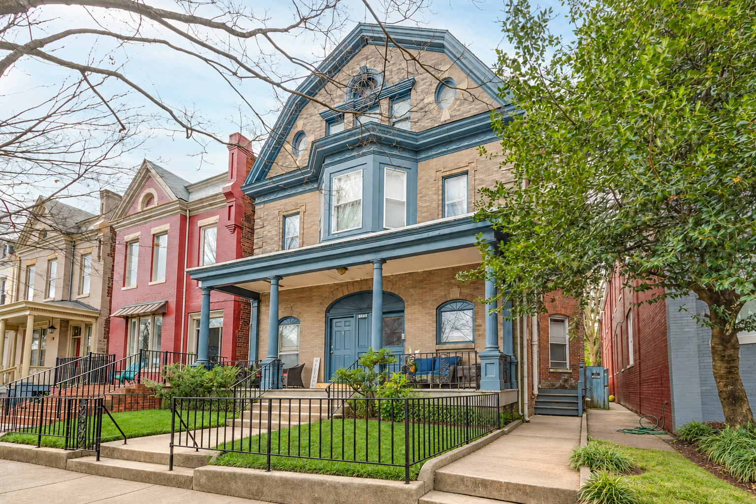 Richmond brick home with blue-gray porch columns and front doors